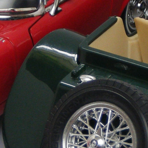 Close-up of vintage toy cars in green and red.Classic cars on display, red and green with chrome wheels