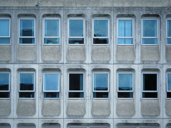 Facade of a building with rows of windows.Facade of a building with patterned windows.