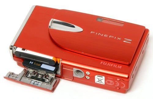 Red Fujifilm FinePix Z20fd camera with open battery compartment.Fujifilm FinePix Z20fd digital camera with open battery compartment.