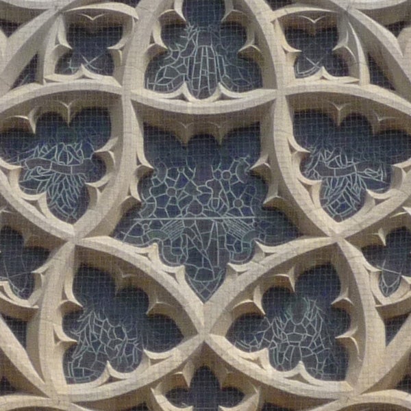 Close-up of intricate gothic architectural stone tracery.Close-up photo of intricate stone tracery and stained glass.