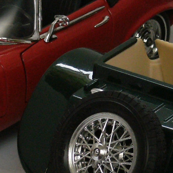 Vintage red and green sports cars close-up.Detailed model cars showcasing intricate design and craftsmanship