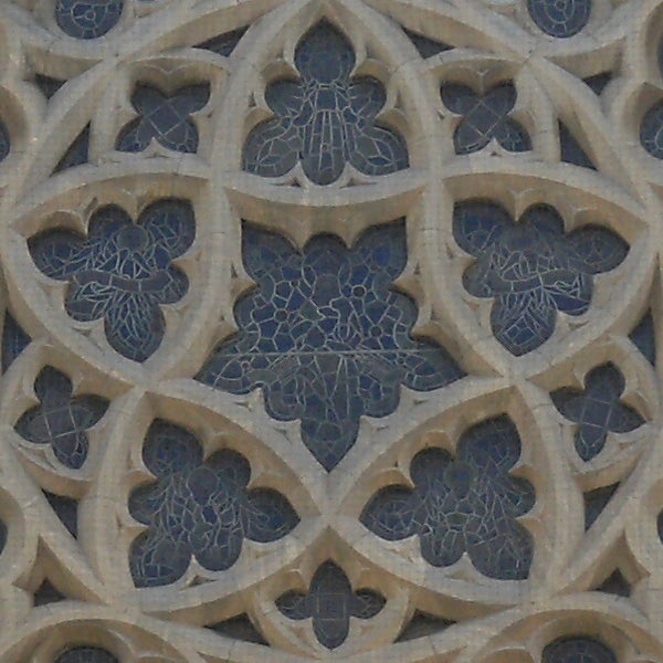 Detailed stonework pattern on building facade.Intricate stone carving patterns on a wall.