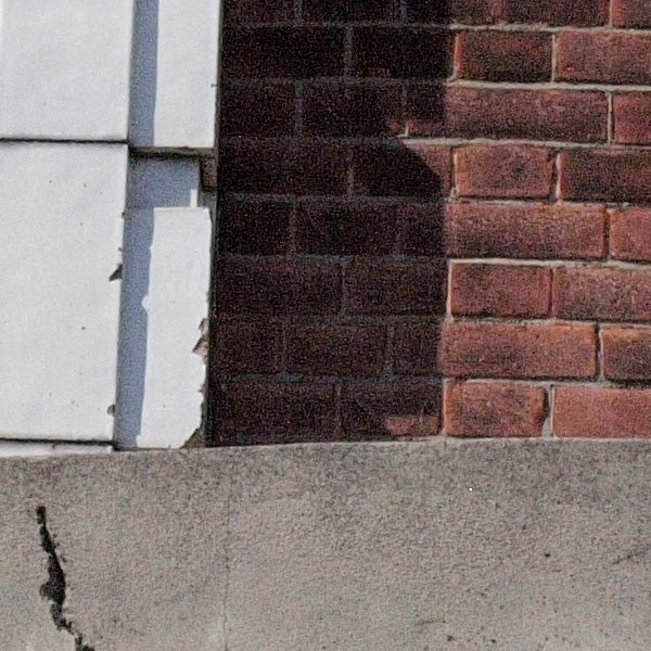 Close-up photo showing texture and detail of brick wall.Close-up of brick wall corner showing camera's detail capture.
