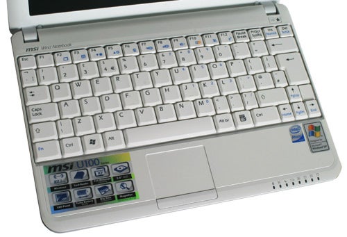 MSI Wind U100 netbook with Windows XP stickers on palm rest.MSI Wind U100 laptop with open lid showing keyboard and screen.