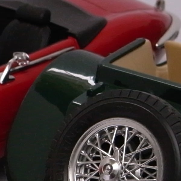 Close-up of classic red car model wheel and fender.Close-up of a classic car model's wheel and fender.