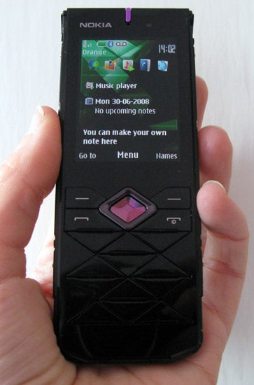 Hand holding a Nokia 7900 Crystal Prism phone.Hand holding Nokia 7900 Crystal Prism phone displaying screen.
