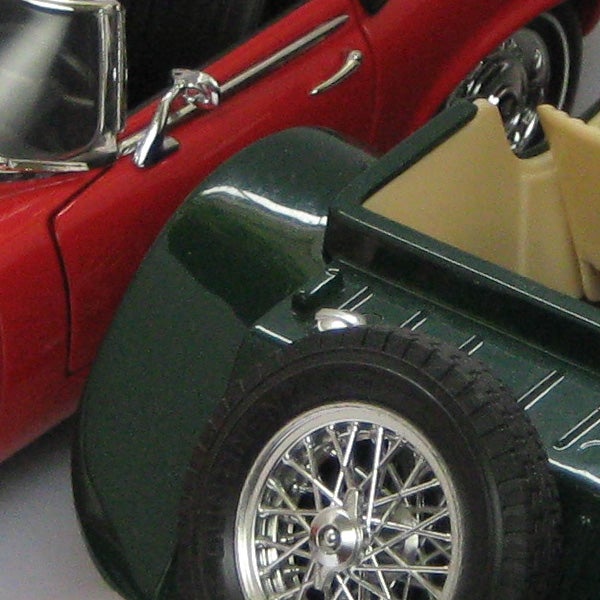 Close-up of a miniature red and green vintage car model.Close-up of a toy model car with intricate details