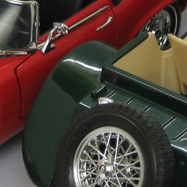 Close-up of a green and red vintage toy car model.Close-up of a vintage red and green model car
