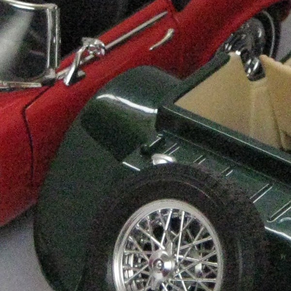 Close-up of a green and red toy car models.Low-resolution photo of model cars taken with Canon PowerShot A470.