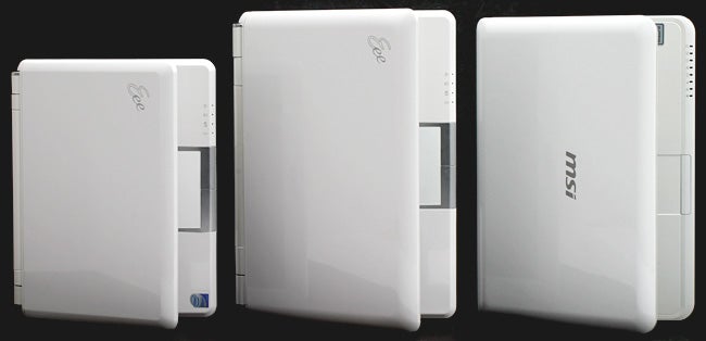 Three Asus Eee PC 1000 netbooks in different orientations.Three Asus Eee PC 1000 netbooks displayed side by side.