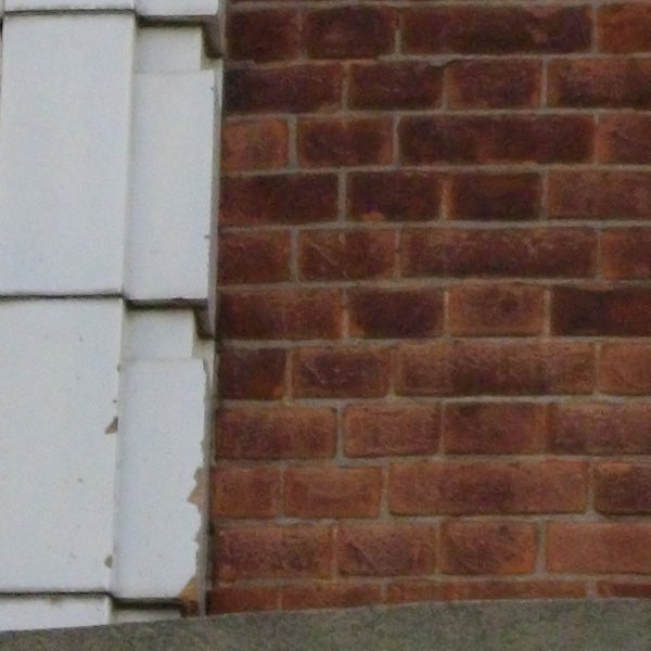 Pentax Optio E50 camera sample showing brick wall texture.Brick wall and window corner with peeling paint