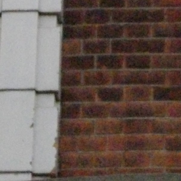 Low-resolution photo of a brick wall with noise.image of a brick wall, possible camera issue.