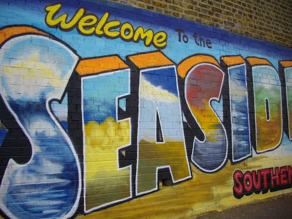 Colorful seaside welcome graffiti on a wallGraffiti wall art welcoming to the seaside
