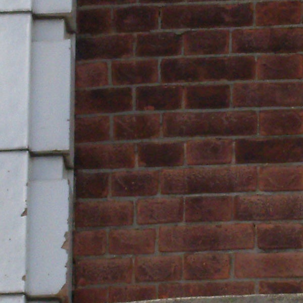 Close-up of a red brick wall with visible textures.