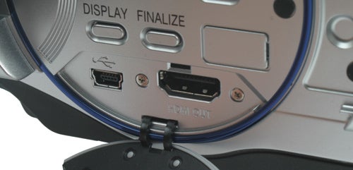 Close-up of Hitachi DZ-BD70E camcorder ports and buttons.Close-up of Hitachi DZ-BD70E camcorder's port panel