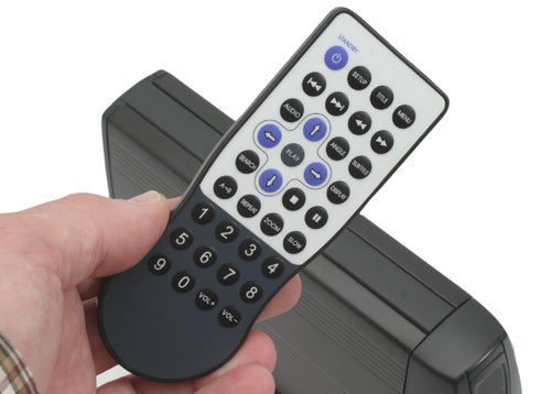 Hand holding a Traxdata MultiMediaDrive remote control.