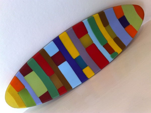 Colorful abstract pattern on surfboard-shaped objectColorful abstract mosaic surfboard design on white background