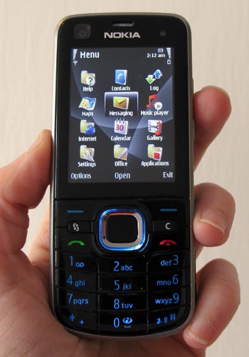 Hand holding a Nokia 6220 Classic showing the menu screen.Hand holding a Nokia 6220 Classic displaying the menu screen.