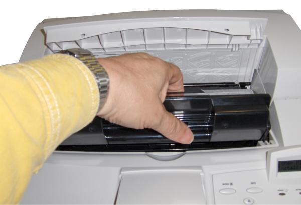 Person replacing toner in OKI B6250 Laser PrinterPerson replacing toner cartridge in OKI B6250 printer.