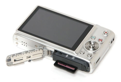 Casio Exilim EX-Z100 camera with open battery compartment.