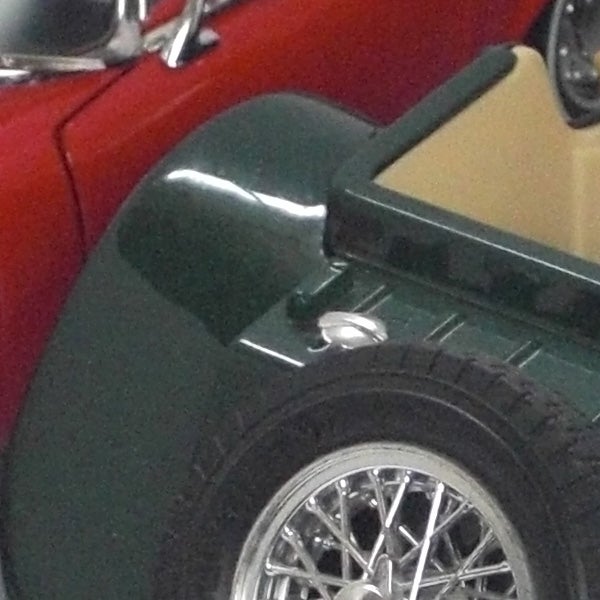Close-up of a vintage car wheel and part of the body.Close-up of a classic car wheel and fender