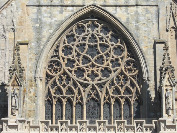 Intricate gothic window architecture with stone tracery.Intricate gothic church window architecture.