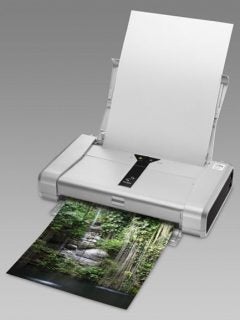 Canon PIXMA iP100 printer with printed color photograph.