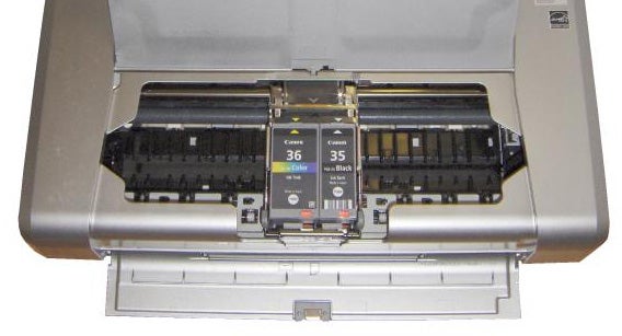 Close-up of Canon PIXMA iP100 printer with open ink cartridge bay.Canon PIXMA iP100 printer with open ink cartridge compartment.