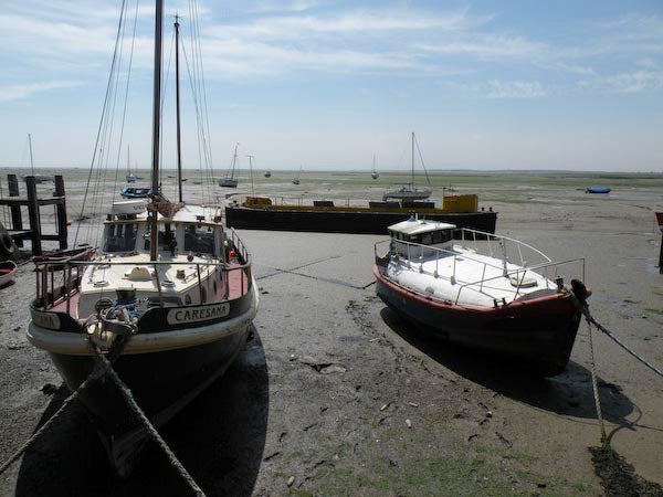 Photo taken with Nikon Coolpix P80 showing boats on dry seabed.Two boats on dry seabed at low tide