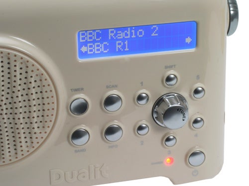 Close-up of a cream-colored Dualit DAB radio displaying BBC Radio 2.Close-up of a Dualit Lite Radio with digital display and buttons.