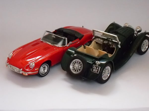 Two model cars, red and green, photographed on a white background.Photo of two model cars, red and green, captured with Samsung L210.