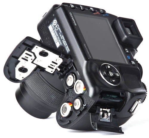 Olympus SP-570 UZ camera showing battery compartment.Olympus SP-570 UZ camera showing open battery compartment.