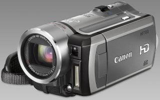 Canon HF100 camcorder with lens and branding visible.