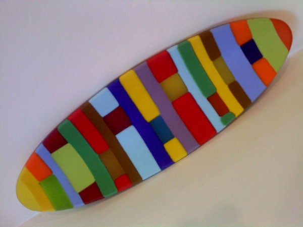Colorful abstract surfboard-shaped artwork on white background.Colorful abstract pattern on surfboard-shaped object