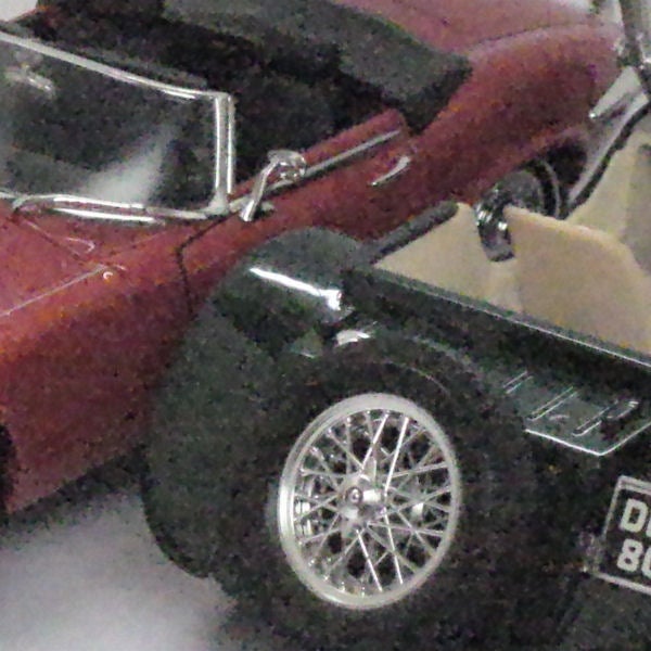 Close-up of die-cast model cars showcasing intricate detailsClose-up of a classic red convertible car model.
