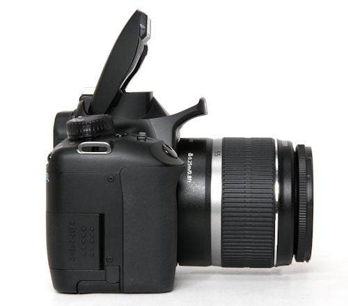 Canon EOS 1000D DSLR camera with flash open.Canon EOS 1000D DSLR with lens and open flash.