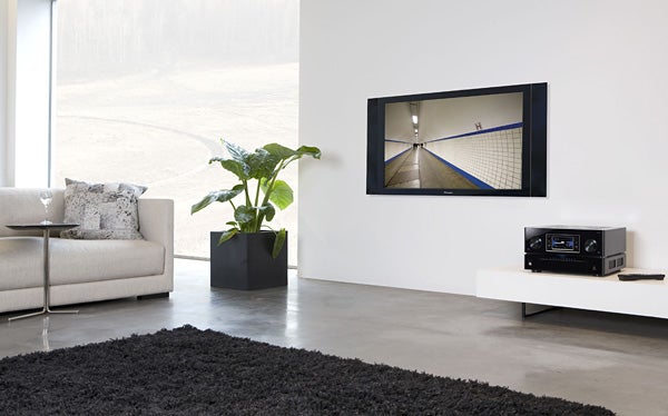 Pioneer Kuro plasma TV in modern living room setup.Pioneer plasma TV on wall in modern living room setup