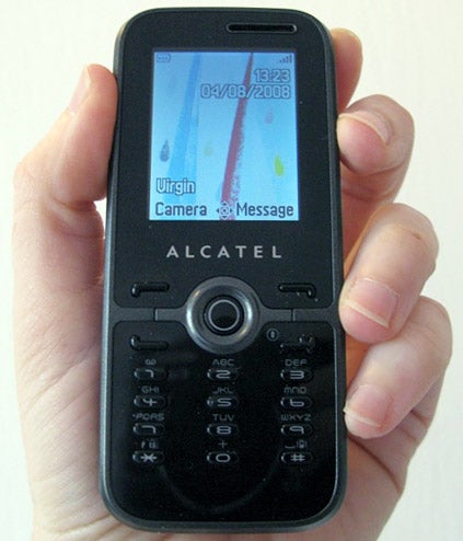 Hand holding Alcatel OT-S520 mobile phone displaying screen.