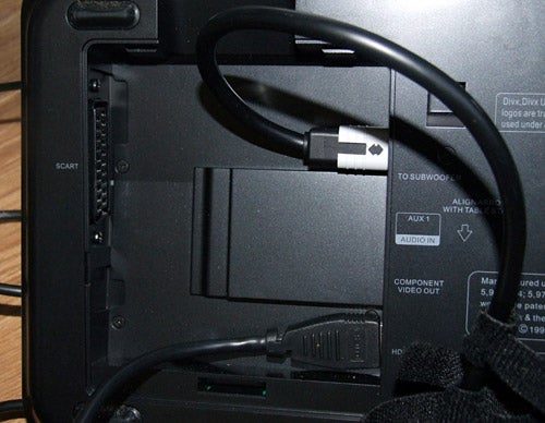 Close-up of Philips Cinema System rear inputs and cables connected.Close-up of Philips home cinema system's rear connectivity ports.