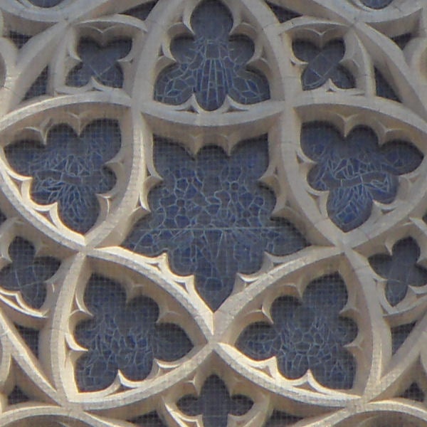 Intricate stone lattice work showing traditional design patterns.Decorative stone lattice work with floral patterns.
