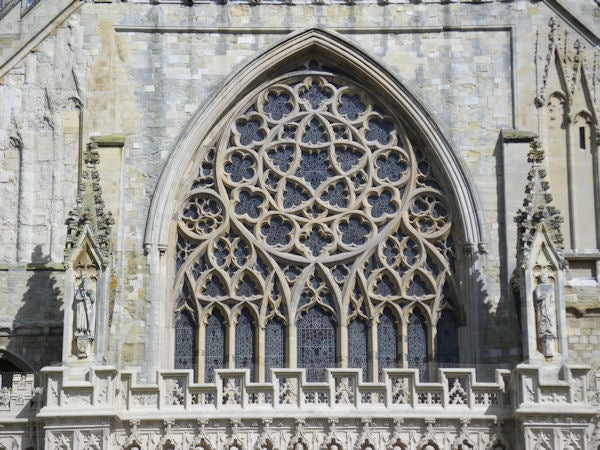 Detailed architecture of a cathedral's ornate window.Intricate cathedral window architecture captured with sharp detail.