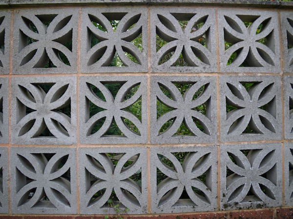 Ornate concrete wall with geometric patternsDecorative concrete block wall with geometric patterns.