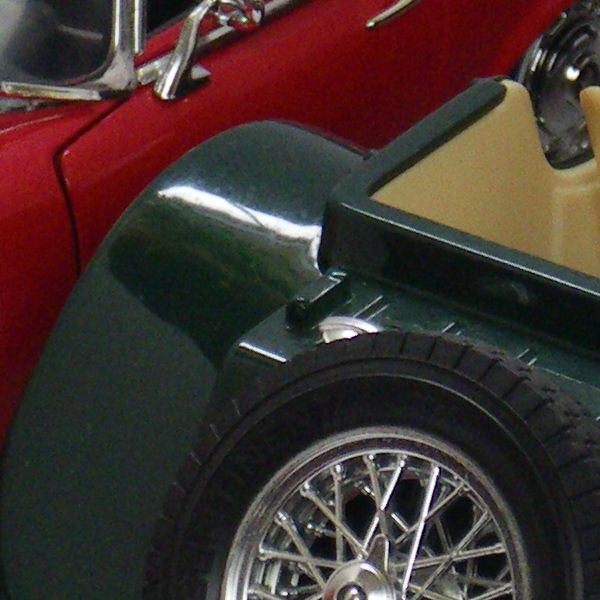 Close-up of vintage toy cars showcasing camera's macro ability.Close-up of vintage toy cars showing detail and color.