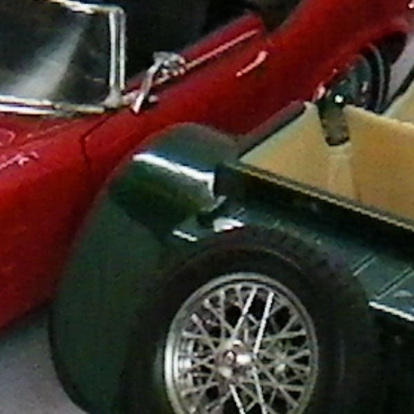 Close-up of vintage red and green model carsClose-up of a classic red and green car models