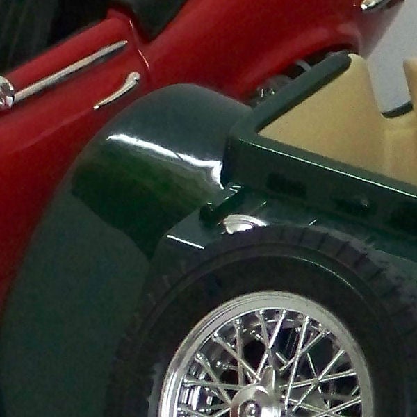 Close-up of a classic car wheel and fender.Close-up of a vintage car's wheel and fender.