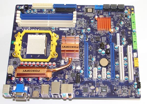 Foxconn A7DA-S AMD 790GX Motherboard on white background.Foxconn A7DA-S AMD 790GX Motherboard with heat sinks and slots.