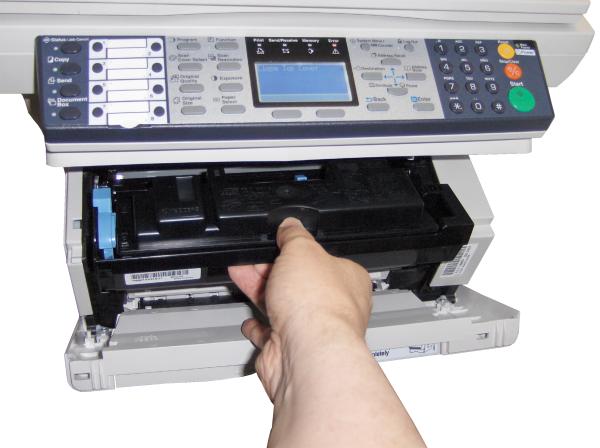 Hand replacing toner cartridge in Kyocera Mita FS-1118MFP.Person replacing toner in Kyocera FS-1118MFP multifunction printer.