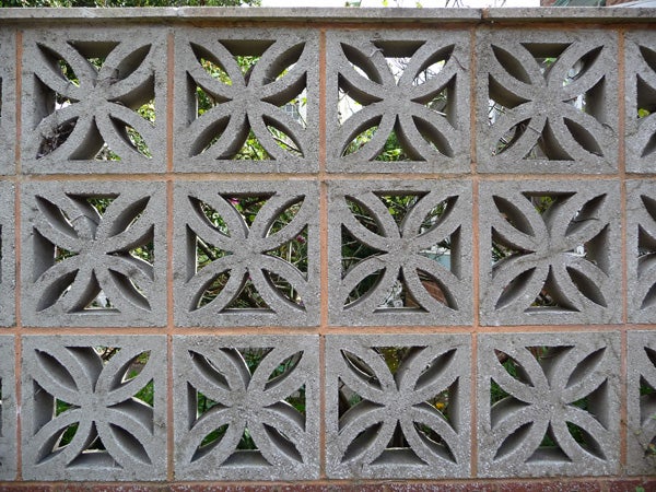 Decorative cinder block wall with leaf patterns.Decorative concrete breeze blocks with leaf patterns.