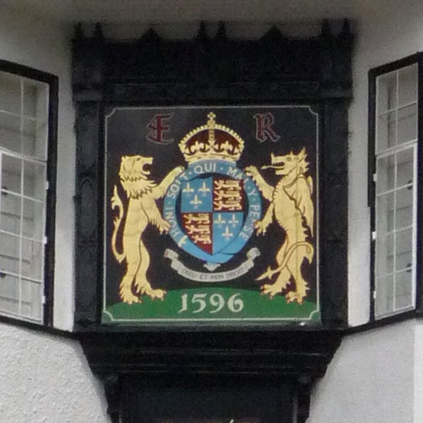 Coat of arms with lions and date 1596 displayed on a wall.Coat of arms on a building facade with the year 1596.