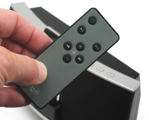 Hand holding Klipsch iGroove SXT speaker remote control.